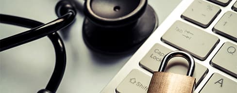 Lock and stethoscope on top of a keyboard.