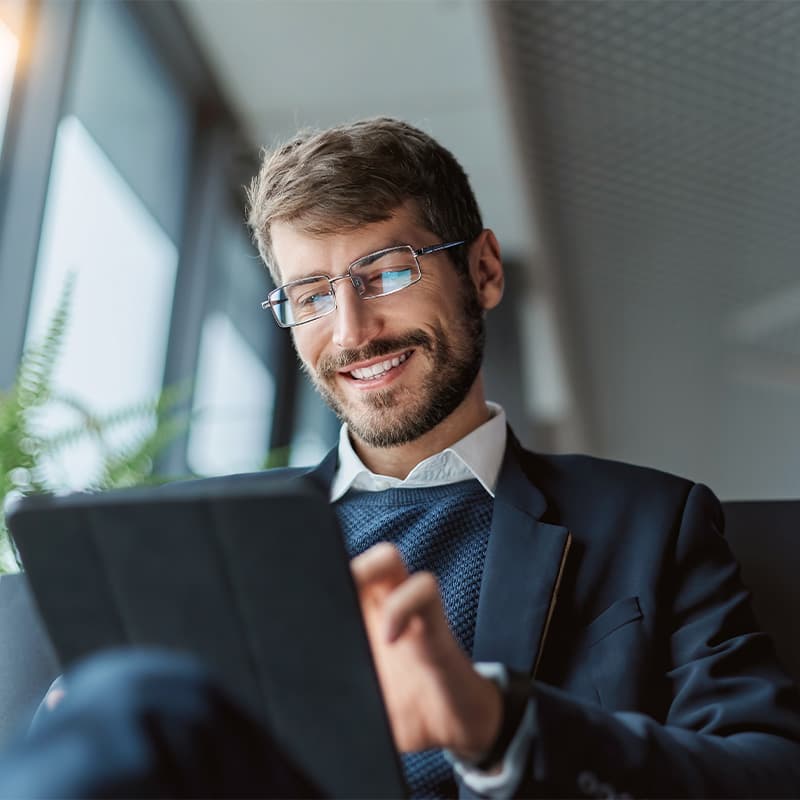 Businessman looking down at tablet