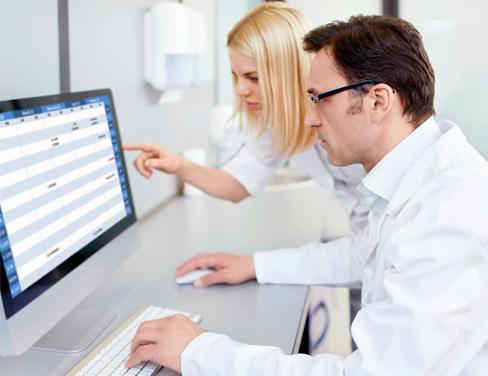 Two doctors reviewing information on a computer