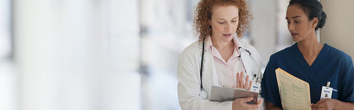 Nurse and doctor looking at patient files