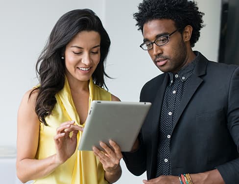 co-workers looking at tablet