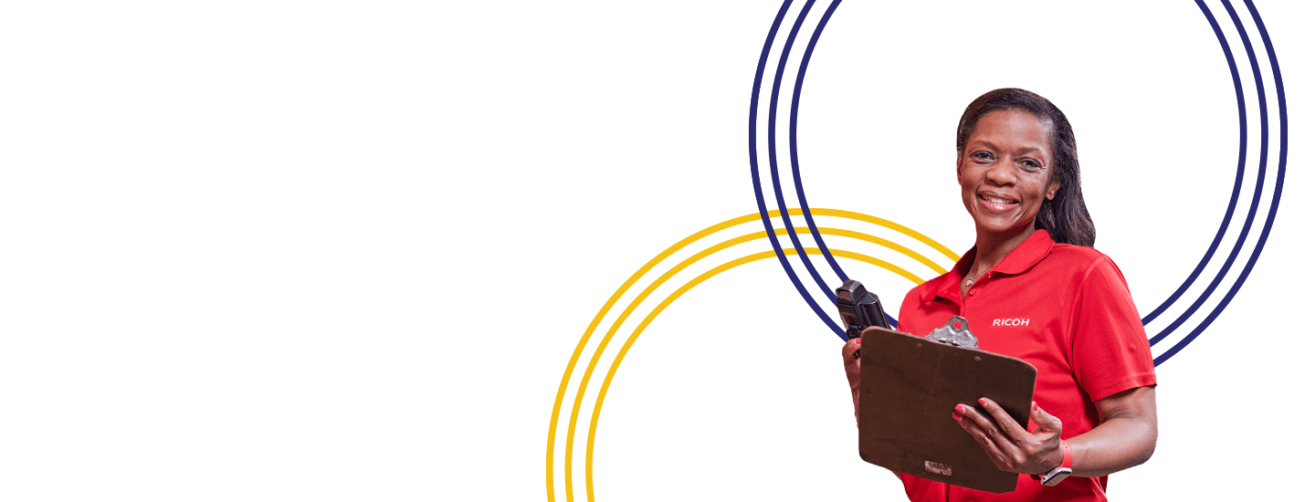 Woman in red shirt and holding a clip board looking at camera