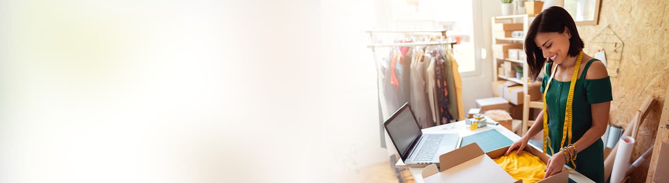 store business owner packing clothes for delivery