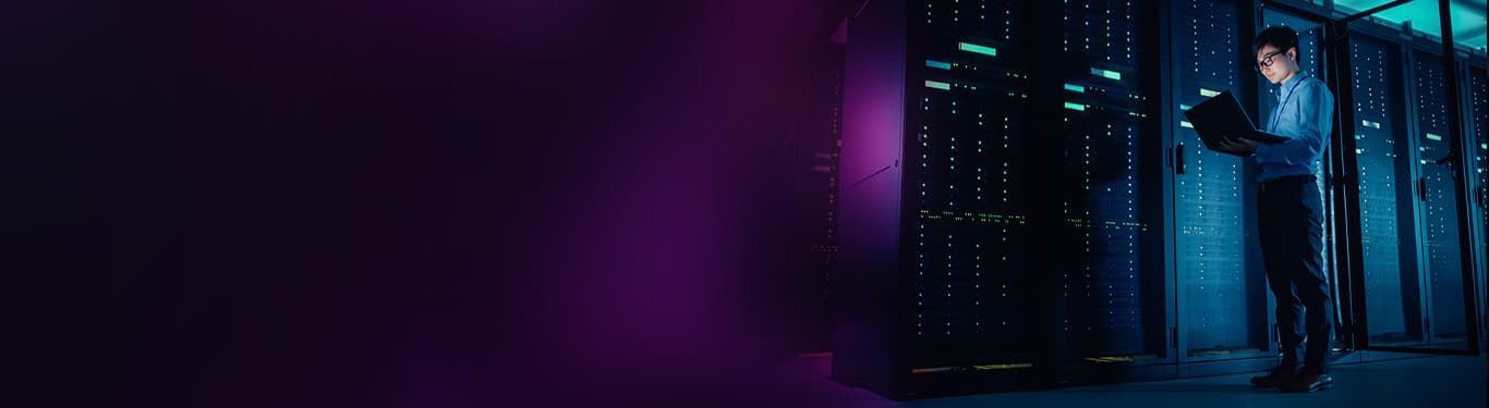 Male IT Technician Running Maintenance Programme on a Laptop